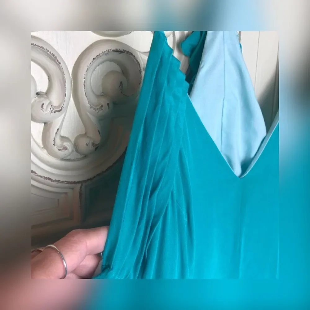 Turquoise wink romper with ruffle details size small
